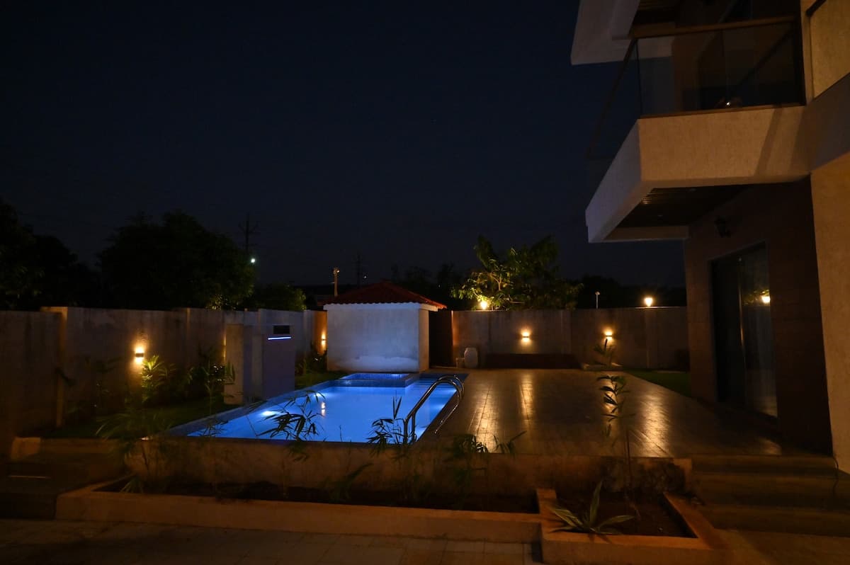 Pool area at sunset at Aurai Villa
